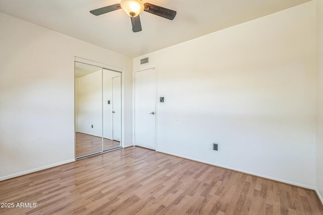 3833 W Phelps Rd, Phoenix, AZ 85053 - unfurnished bedroom with light wood finished floors, a closet, baseboards, and a ceiling fan
