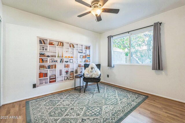 3833 W Phelps Rd, Phoenix, AZ 85053 - living area featuring wood finished floors, baseboards, and ceiling fan