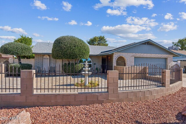 3833 W Phelps Rd, Phoenix, AZ 85053 - ranch-style home with a fenced front yard, brick siding, a garage, and roof with shingles