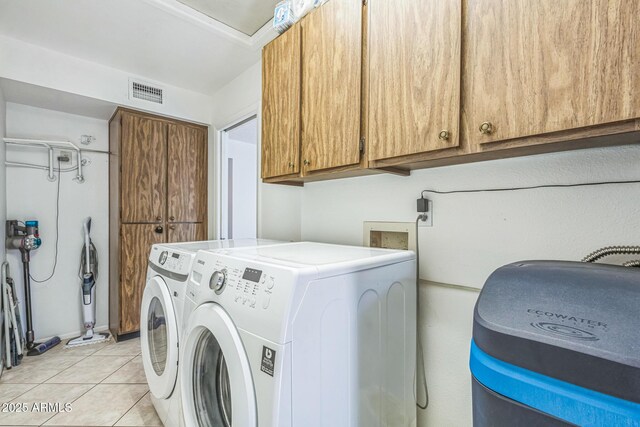 3833 W Phelps Rd, Phoenix, AZ 85053 - laundry area featuring cabinet space, separate washer and dryer, and light tile patterned floors