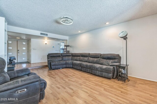 3833 W Phelps Rd, Phoenix, AZ 85053 - living area featuring a textured ceiling, wood finished floors, and recessed lighting