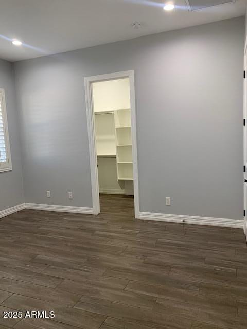 2319 N 192nd Ave, Buckeye, AZ 85396 - empty room featuring baseboards and dark wood-type flooring