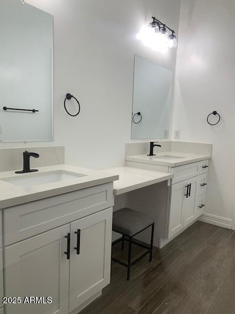 2319 N 192nd Ave, Buckeye, AZ 85396 - bathroom with a sink, two vanities, baseboards, and wood finished floors