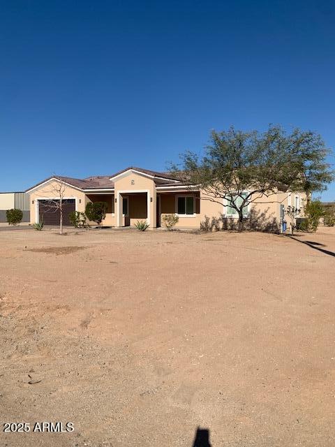 2319 N 192nd Ave, Buckeye, AZ 85396 - view of front of house featuring stucco siding, an attached garage, and roof mounted solar panels