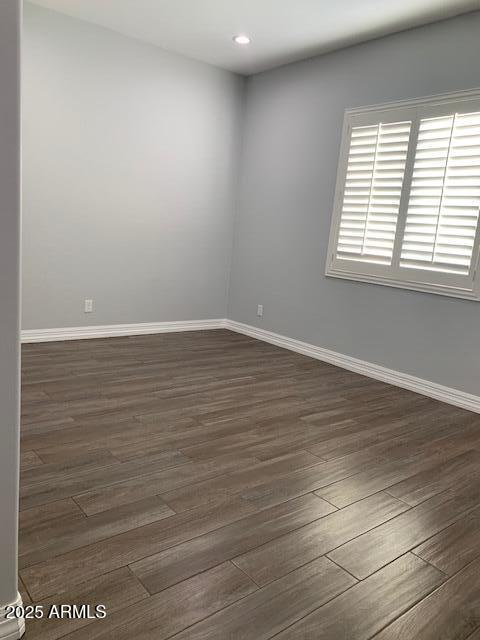 2319 N 192nd Ave, Buckeye, AZ 85396 - spare room with dark wood finished floors, baseboards, and recessed lighting