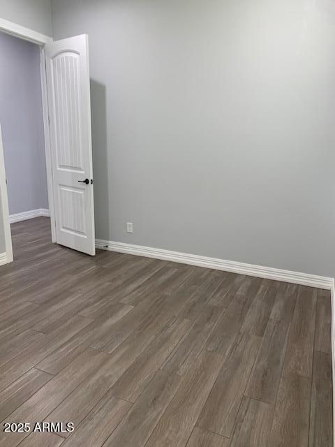 2319 N 192nd Ave, Buckeye, AZ 85396 - empty room featuring baseboards and dark wood finished floors