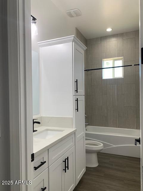 2319 N 192nd Ave, Buckeye, AZ 85396 - full bath featuring toilet, vanity, shower / bathtub combination, and wood finished floors