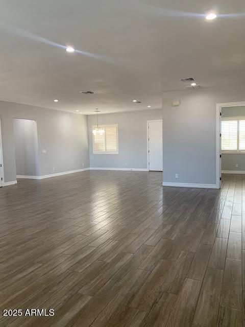 2319 N 192nd Ave, Buckeye, AZ 85396 - unfurnished room featuring recessed lighting, baseboards, a chandelier, and dark wood finished floors