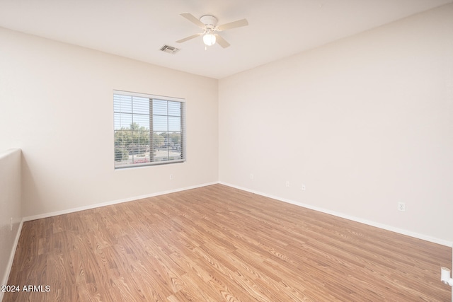 spare room with ceiling fan and light wood-type flooring