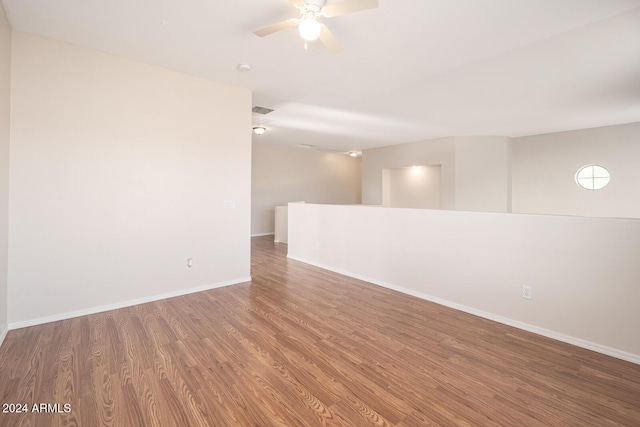 empty room with hardwood / wood-style flooring and ceiling fan