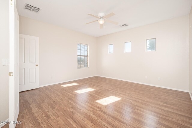 empty room featuring ceiling fan and light wood-type flooring