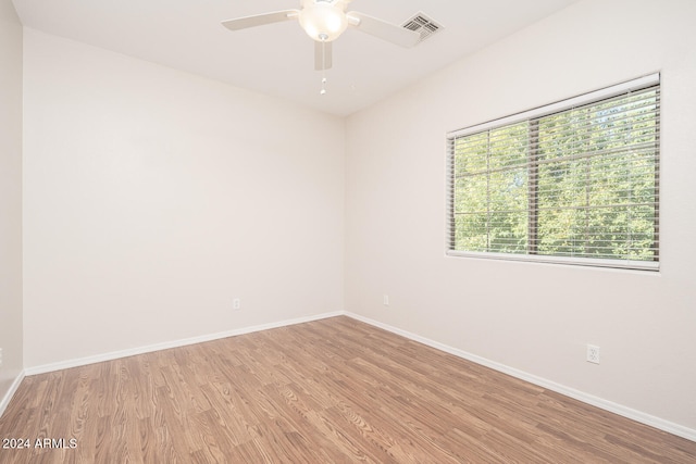 spare room with ceiling fan and light wood-type flooring