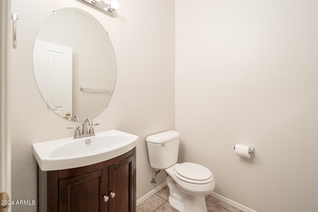 bathroom featuring tile patterned flooring, vanity, and toilet