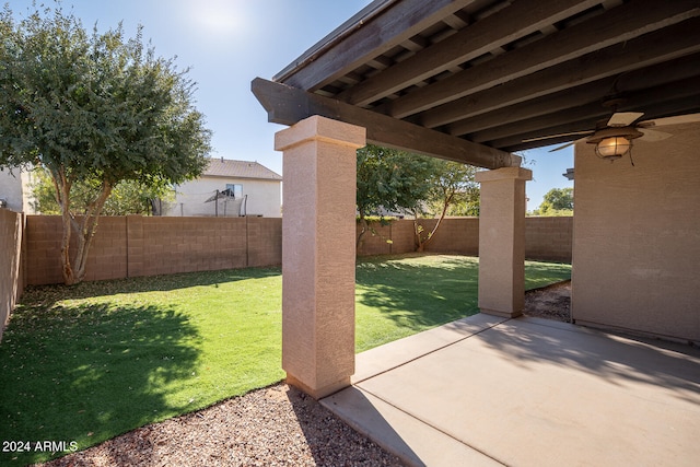 view of yard featuring ceiling fan and a patio