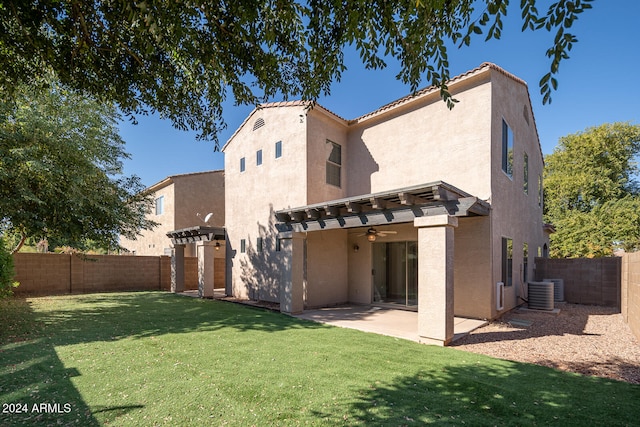 rear view of house with a pergola, a patio, ceiling fan, central AC, and a yard