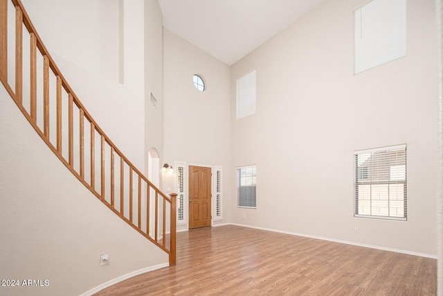 entryway featuring high vaulted ceiling and hardwood / wood-style flooring