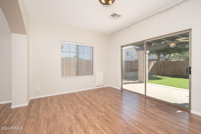 empty room with hardwood / wood-style flooring