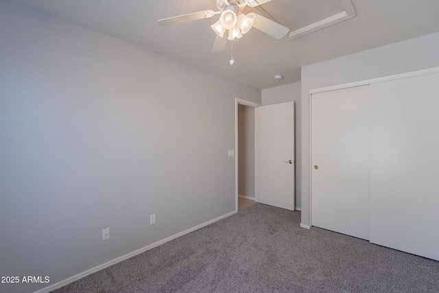 unfurnished bedroom with carpet, a closet, ceiling fan, and baseboards