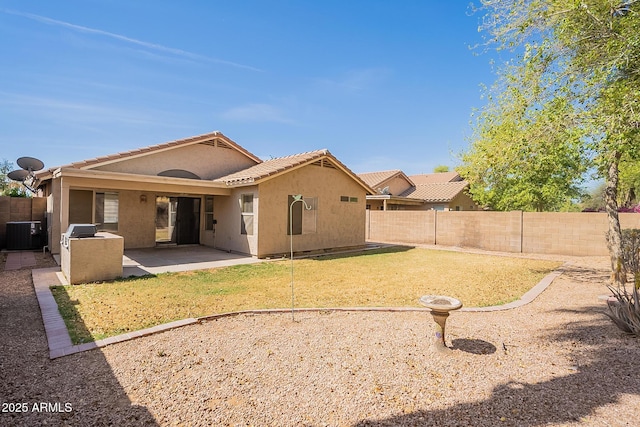 rear view of property featuring a fenced backyard, a tile roof, central air condition unit, a patio area, and stucco siding