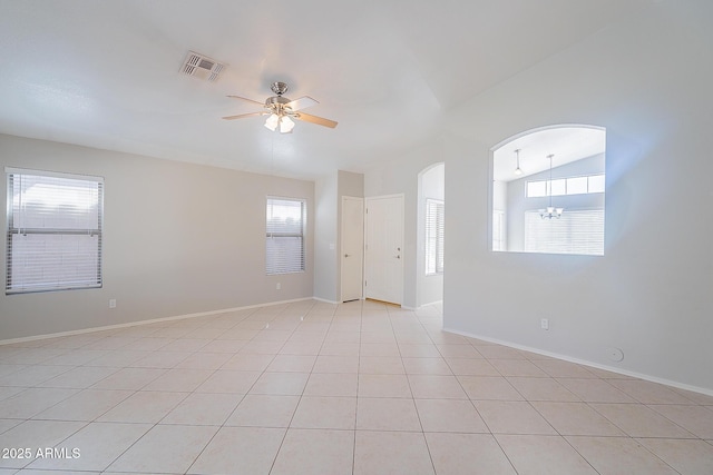 unfurnished room featuring light tile patterned floors, visible vents, arched walkways, vaulted ceiling, and ceiling fan with notable chandelier