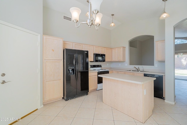 kitchen with light tile patterned floors, visible vents, light countertops, light brown cabinetry, and black appliances