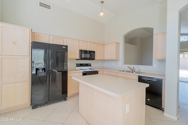 kitchen featuring light tile patterned floors, visible vents, light brown cabinetry, black appliances, and a sink