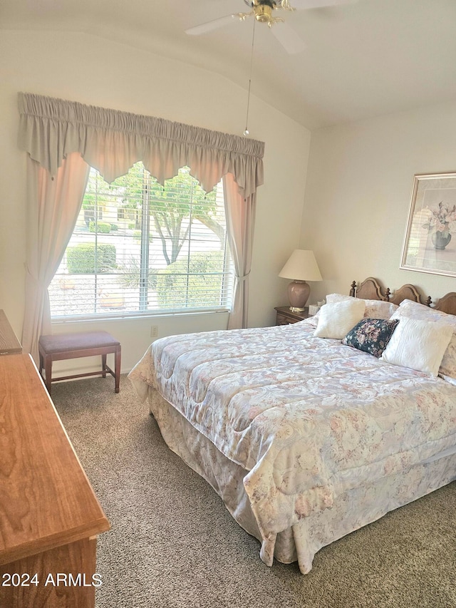 carpeted bedroom with ceiling fan, lofted ceiling, and multiple windows