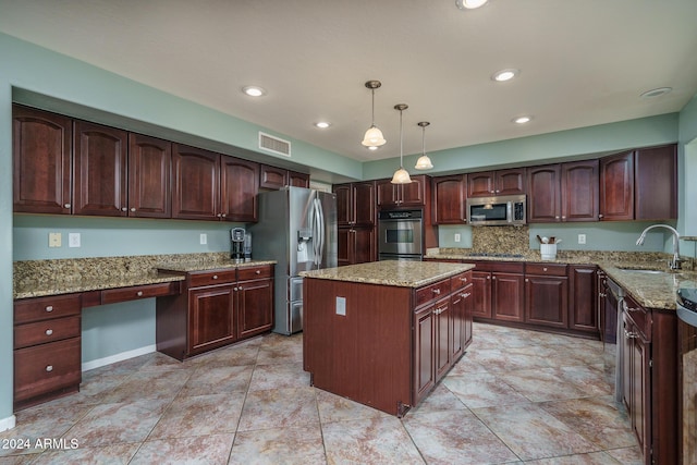 kitchen featuring light stone counters, stainless steel appliances, sink, a kitchen island, and hanging light fixtures