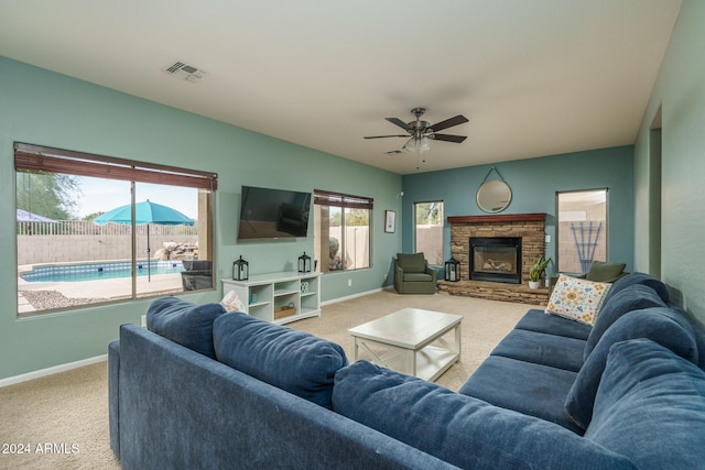 living room featuring ceiling fan, plenty of natural light, and carpet