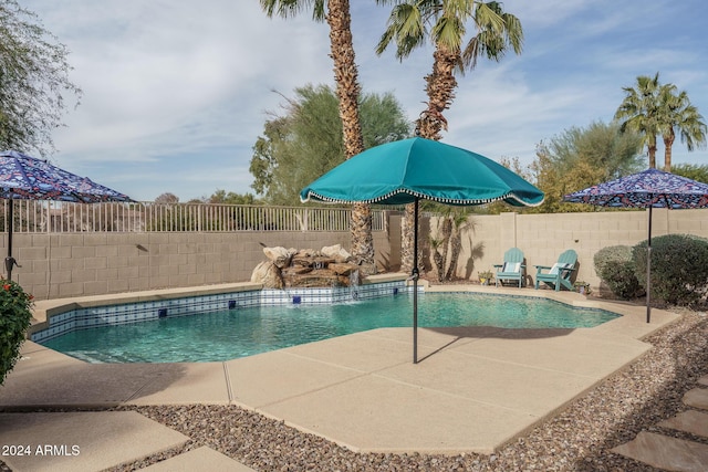 view of pool featuring pool water feature and a patio area