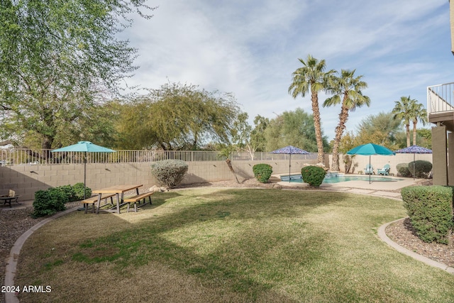 view of yard with a fenced in pool