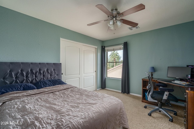 bedroom with ceiling fan, a closet, and light colored carpet