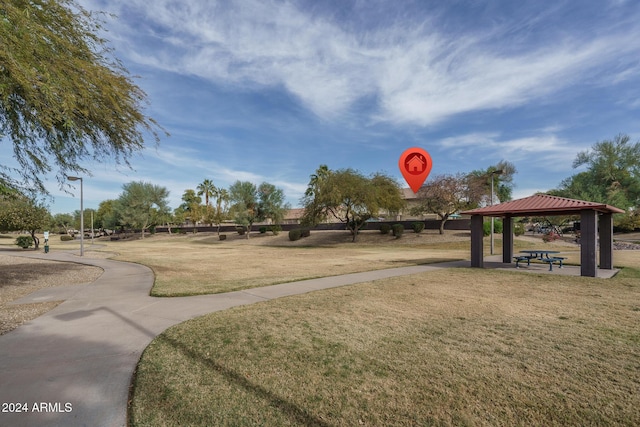 surrounding community with a gazebo and a yard