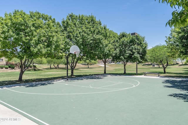 view of sport court with a yard