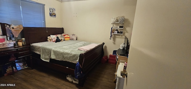 bedroom featuring dark hardwood / wood-style flooring