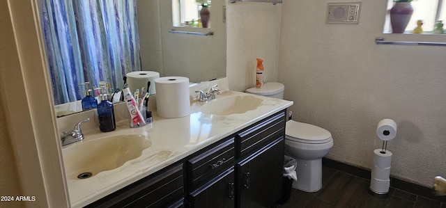 bathroom with wood-type flooring, vanity, and toilet