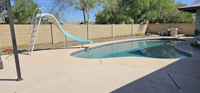 view of pool featuring a patio and a water slide