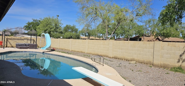 view of pool with a gazebo, a diving board, and a water slide