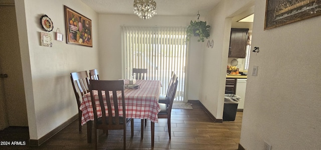 dining space with a textured ceiling, dark hardwood / wood-style flooring, an inviting chandelier, and a healthy amount of sunlight