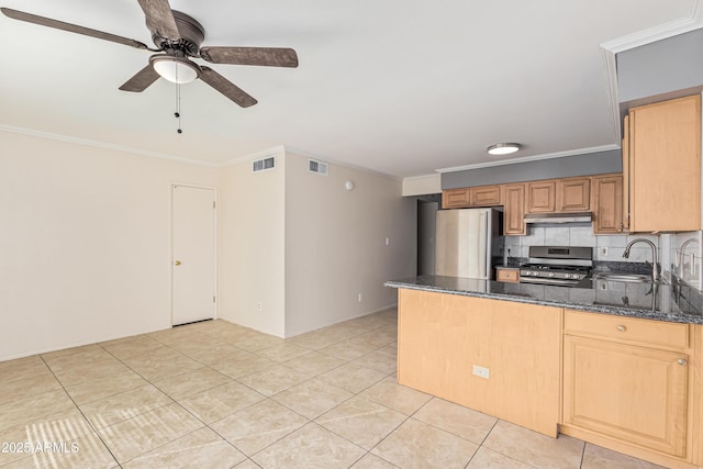 kitchen with appliances with stainless steel finishes, dark stone countertops, ornamental molding, and kitchen peninsula