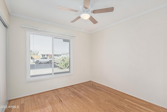 unfurnished room with ceiling fan, wood-type flooring, and crown molding