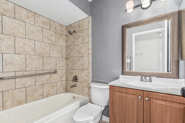 full bathroom with toilet, vanity, and tiled shower / bath