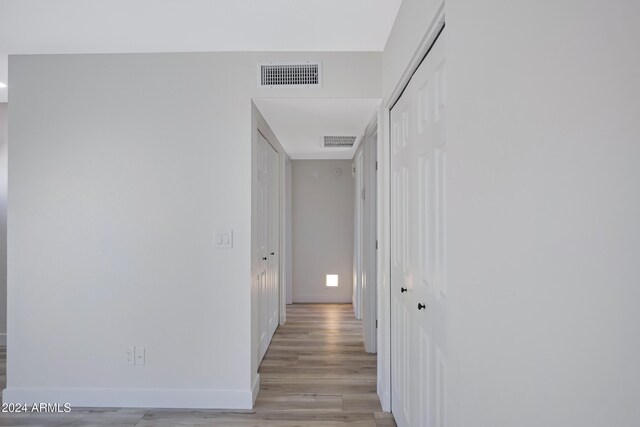 hall with light hardwood / wood-style floors