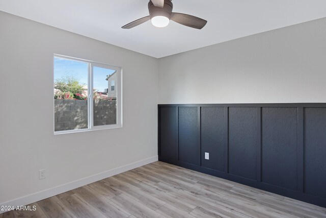 spare room with light hardwood / wood-style flooring and ceiling fan