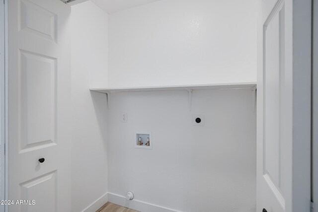 laundry area with hookup for an electric dryer, light hardwood / wood-style floors, gas dryer hookup, and hookup for a washing machine