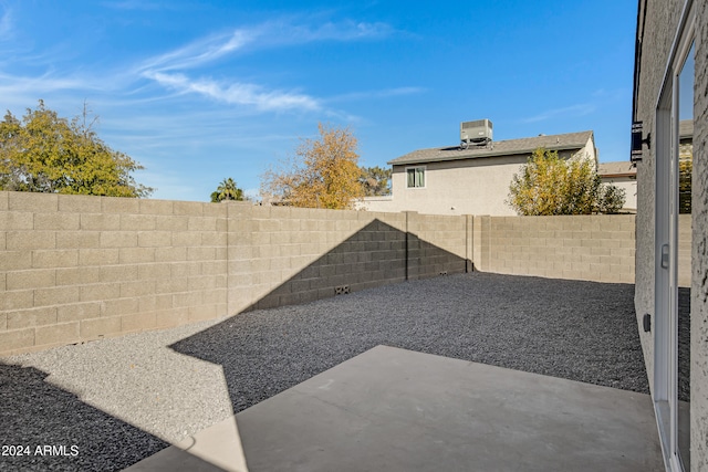 view of yard featuring central air condition unit and a patio area