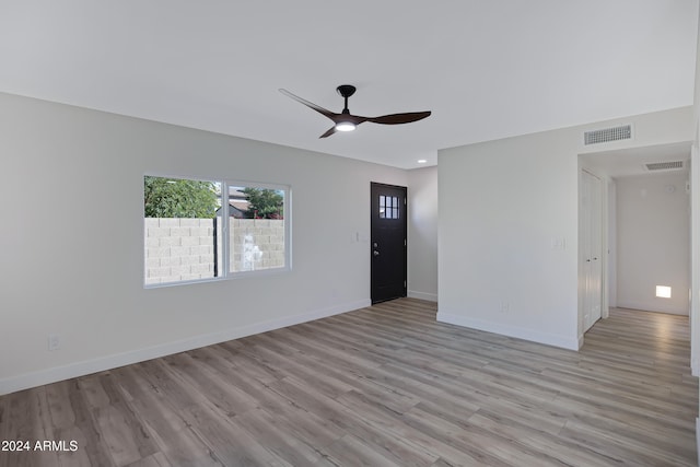 unfurnished living room featuring ceiling fan and light hardwood / wood-style flooring