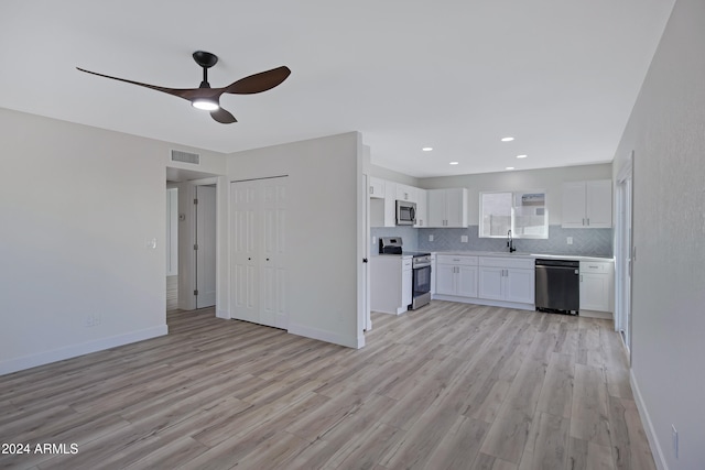 kitchen featuring white cabinets, stainless steel appliances, light hardwood / wood-style flooring, and sink