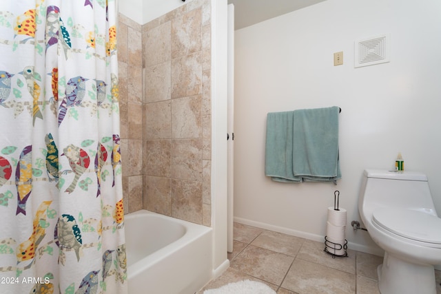 bathroom featuring tile patterned floors, shower / bath combination with curtain, and toilet