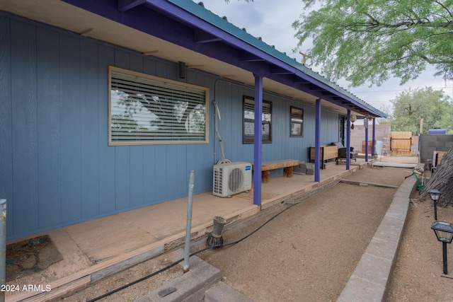 view of side of property with ac unit and a patio area